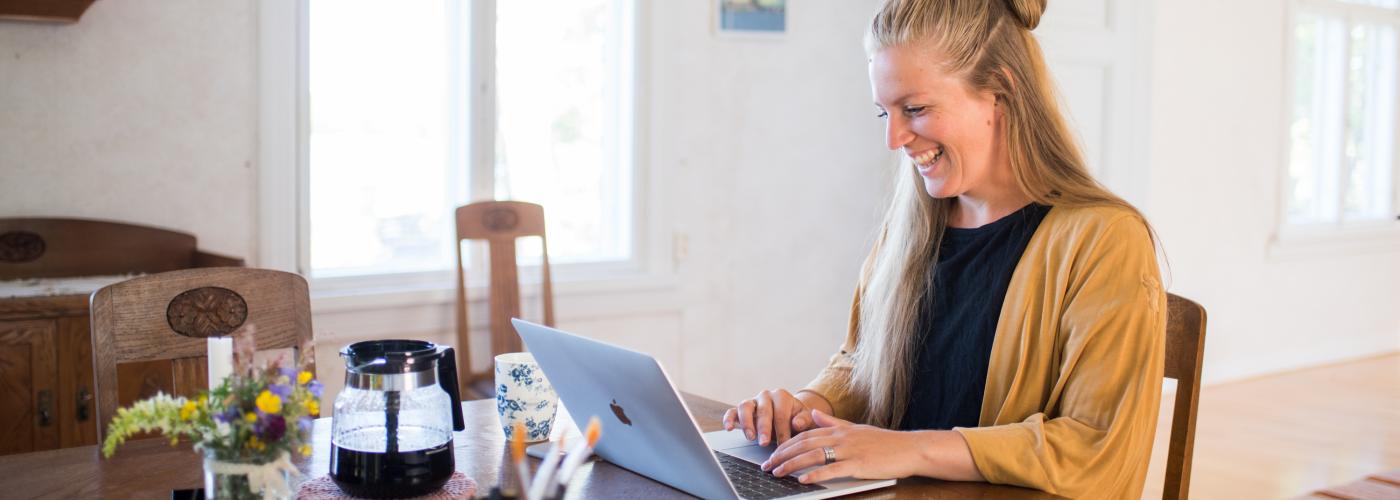 Kvinna som sitter och jobbar vid datorn. 